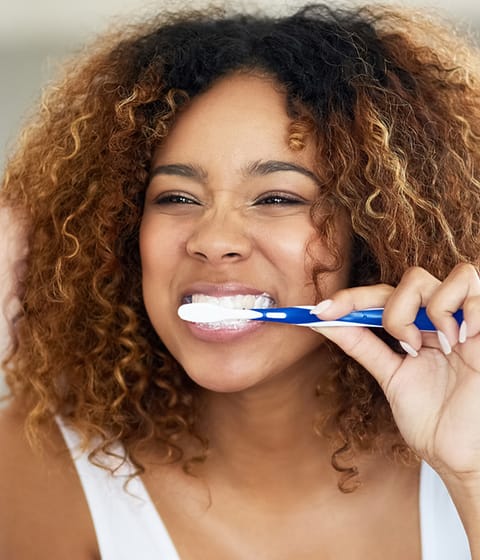 girl brushing her teeth